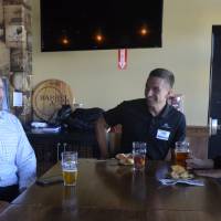 Three Seidman Alumni having a laugh at Social held at Founders Brewing